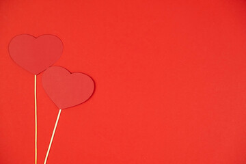 Two red hearts on red background. Text space. Top view