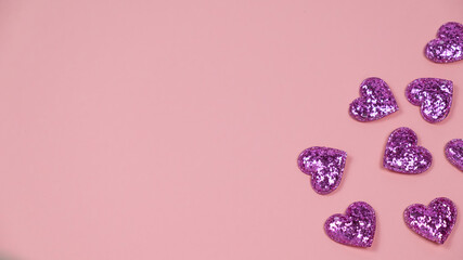 Violet hearts on pink background. Copy space