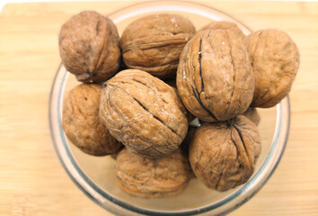 walnuts in a bowl,walnuts on a wooden table