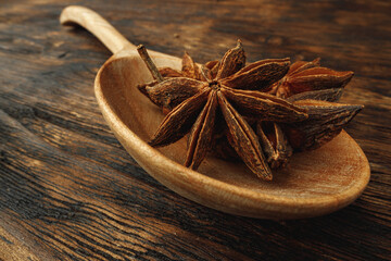 Macro photo of anise stars on wooden background