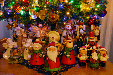 colorful Christmas figures standing in front of the tree