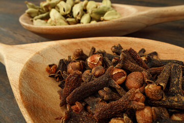 Heap of clove spice on wooden table
