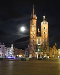 Fototapeta na wymiar Saint Marys church in Krakow, Poland, Christmas tree, full moon