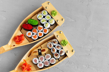 Set of maki sushi on wooden boat tray