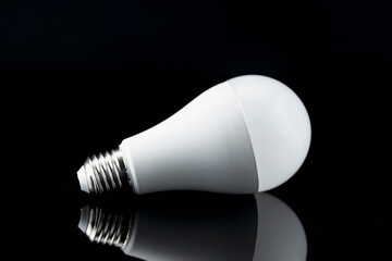 Light Bulb on Black Background with Reflection