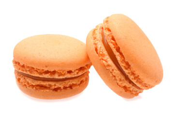 Orange macaroons with filling sweet almond cakes closed up isolated on white