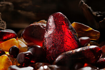 Beauty of natural amber. Several dark red natural amber stones in a cave.