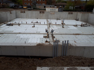 A modern residential building with a new building construction site
