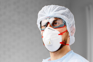 Young male doctor wearing protective medical uniform