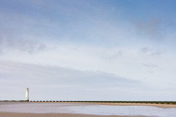 Fototapeta na wymiar Lighthouse sits on an empty beach