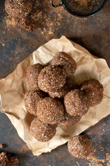 Chocolate coconuts. Chocolate balls with coconut. Chocolate candies or cookies with coconut, cinnamon and powdered sugar	