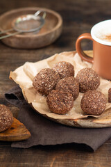 Chocolate coconuts. Chocolate balls with coconut. Chocolate candies or cookies with coconut, cinnamon and powdered sugar	