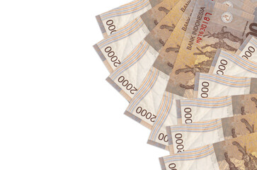 2000 Indonesian rupiah bills lies isolated on white background with copy space. Rich life...