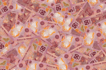 50 mexican pesos bills lies in big pile. Rich life conceptual background
