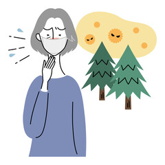 花粉症でくしゃみをするシニア女性（マスク着用）