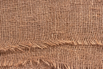 The texture of an uneven crumpled, roughly woven burlap.