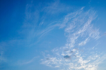 white fluffy clouds in deep blue sky summertime