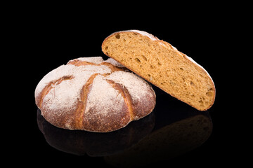 Freshly baked homemade bread isolated on black. Fresh dark rue bread. Healthy eating and traditional bakery, baking bread concept