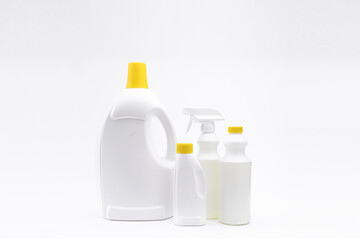 A bunch of bottles of sanitizers and bleach on a white surface