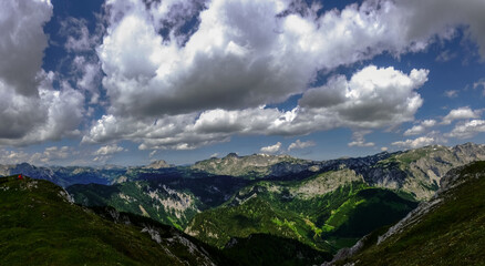 wonderful mountains with large white clouds on the blue sky panorama