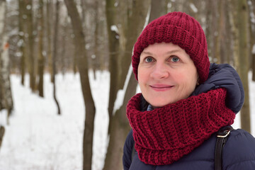 Adult attractive woman walking in winter snowy park