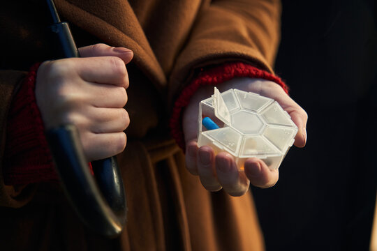 Woman Holding Pill Box With Blue Pill