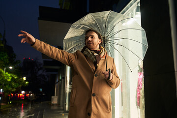 Man standing under the transparent umbrella