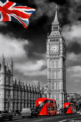 Big Ben with red buses on the bridge against flag of England in London, England, UK