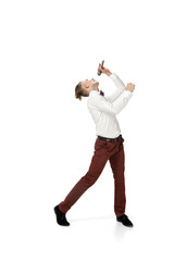 Obraz premium Icon. Happy young man dancing in casual clothes or suit, remaking legendary moves and dances of celebrity from culture history. Isolated on white. Action, motion, fame concept. Creative occupation.