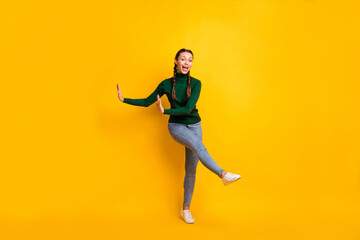 Fototapeta na wymiar Full length body size photo childish playful girl dancing at party on weekend enjoying music isolated on vivid yellow color background