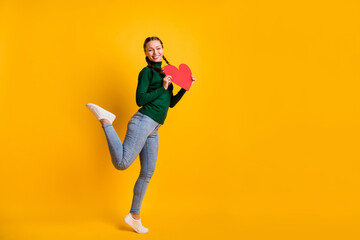Fototapeta na wymiar Full length body size photo laughing girl showing heart love symbol isolated on vivid yellow color background with copyspace