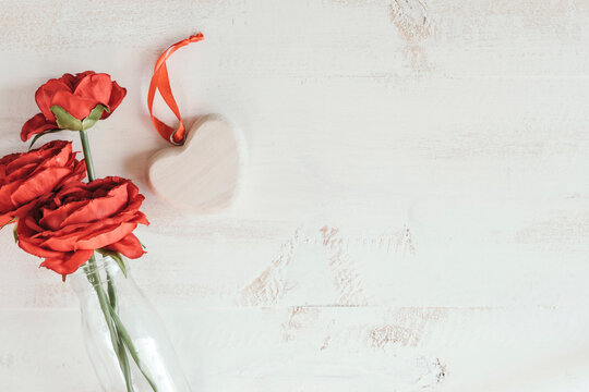 red flowers with wooden heart