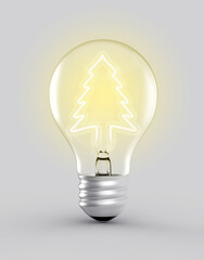 Close up view to a bulb with an ecological filament lit in the shape of a pine, on a grey background
