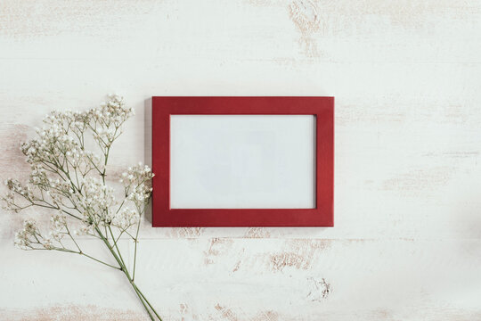 red frame with white flowers on left