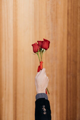 hand holding red roses
