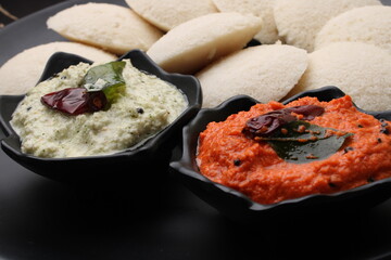 Idly sambar or Idli with Sambhar and green, red chutney. Popular South indian breakfast