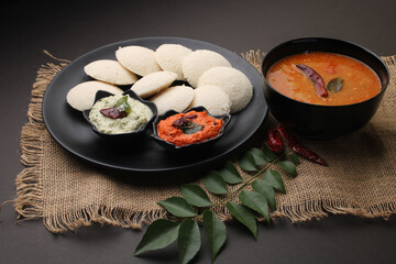 Idly sambar or Idli with Sambhar and green, red chutney. Popular South indian breakfast