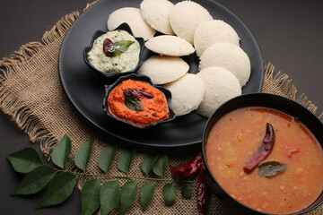 Idly sambar or Idli with Sambhar and green, red chutney. Popular South indian breakfast