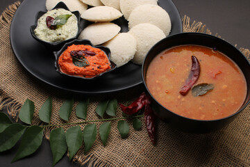 Idly sambar or Idli with Sambhar and green, red chutney. Popular South indian breakfast