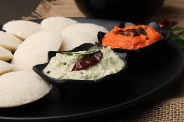 Idly sambar or Idli with Sambhar and green, red chutney. Popular South indian breakfast