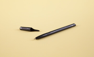 Black pen on an isolated yellow background.