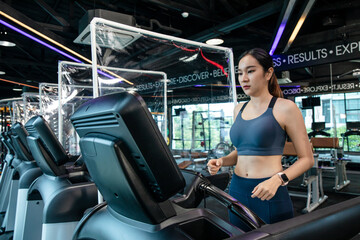 Fototapeta premium Athletic woman workout in the gym have a partition for Treadmill, concept lifestyle social distance