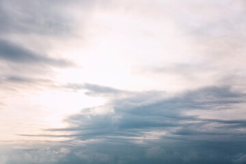 Beautiful blue dramatic sky with clouds at sunrise. Background. Space for text.