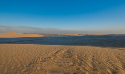 Fototapeta na wymiar Panorama of the desert of Qatar leading to the inland sea..