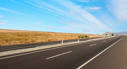 Empty asphalt road with asymmetrical clouds - Nature landscape