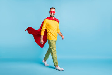 Full length body size photo of hero in mantle mask walking forward smiling isolated on bright blue...