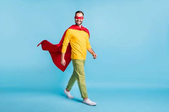 Full length body size photo of hero in mantle mask walking forward smiling isolated on bright blue color background
