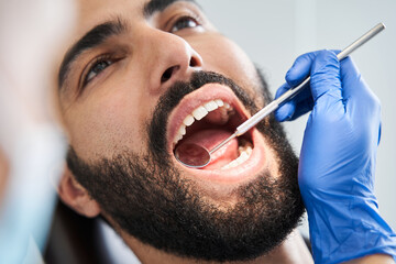 Bearded man in dentist chair ready for regular check up
