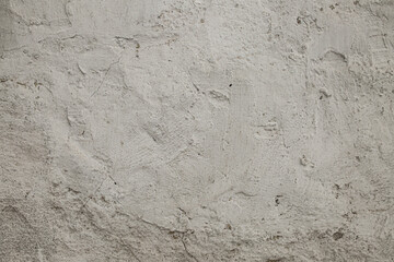 Beautiful texture with light grungy concrete. Grainy background with small cracks and strokes. Building material for decoration and design.