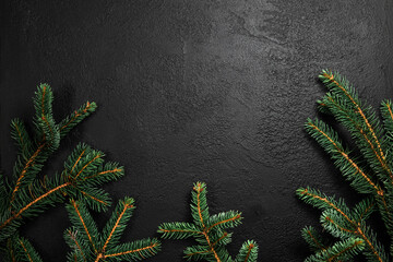 Christmas and New Year holiday frame background. Evergreen spruce branches frame on black background. Flat lay, top view, copy space
